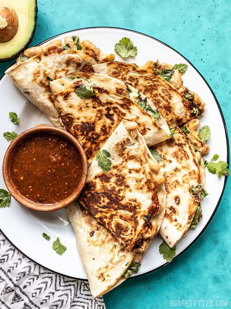 Crispy on the outside, creamy on the inside, these insanely delicious Creamy White Bean and Spinach Quesadillas make an awesomely fast weeknight dinner. Budgetbytes.com A plate full of Creamy White Bean and Spinach Quesadillas with a dish of red salsa