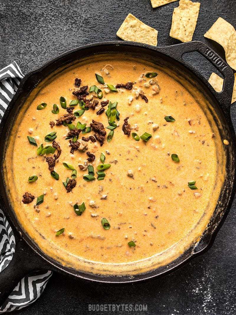 This incredibly easy Spicy Chorizo Cheese Dip only has five ingredients, no processed cheese, and is sure to be the star of your next party! Budgetbytes.com A skillet full of Spicy Chorizo Cheese Dip garnished with green onions.